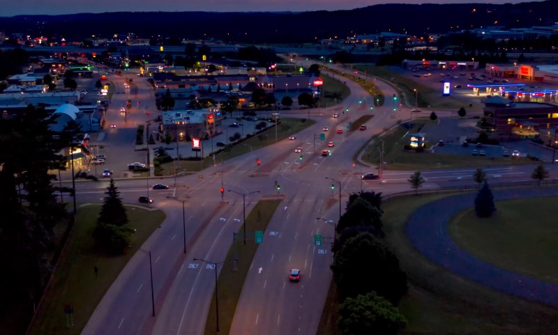 Aerial view of a dimly lit Wausau, busy intersection at twilight